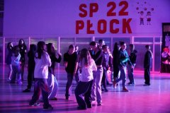 foto_2 grupy uczniów tańczący na forum szkoły w blasku kolorowych świateł
