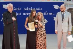 Na scenie stoi nagrodzona Medalem Janusza Korczaka Absolwentka klasy 8b w towarzystwie Pani Dyrektor, Proboszcz Parafii św. Wojciecha i Przewodniczącego Rady Rodziców.