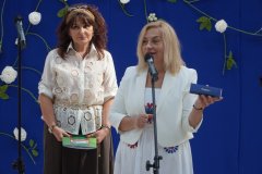 Na tle okolicznościowej dekoracji widać Dyrektora Szkoły- p. Marlenę Błachowicz, prezentującą główną nagrodę w Szkolnym Konkursie Ortograficznym O pióro Dyrektora Szkoły.