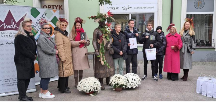 Grupa osób, uczestników gry miejskiej, nauczycieli i organizatorów podczas uroczystego zakończenia.